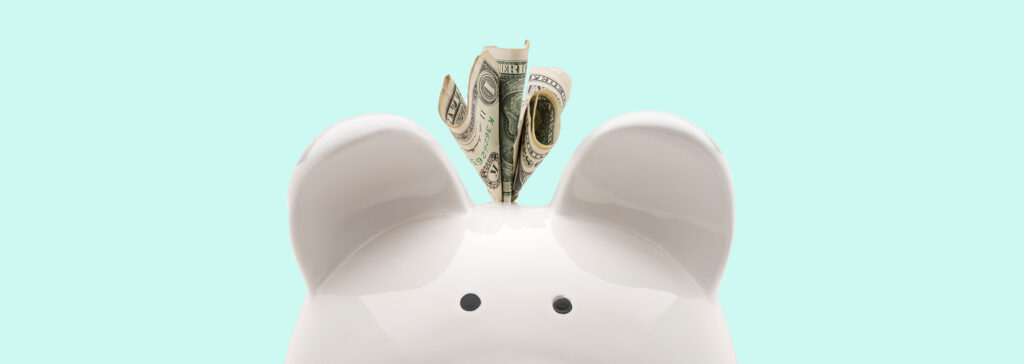 piggy bank with money poking out